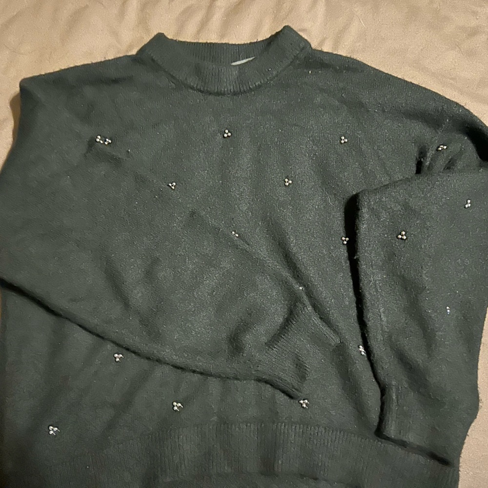 Black sweater. High low affect on the back. Fits more like a small